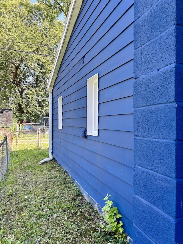 view of side of property featuring fence