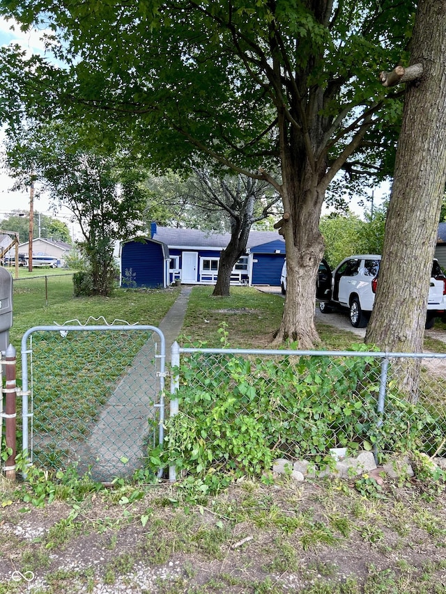 view of yard with a fenced front yard and a gate