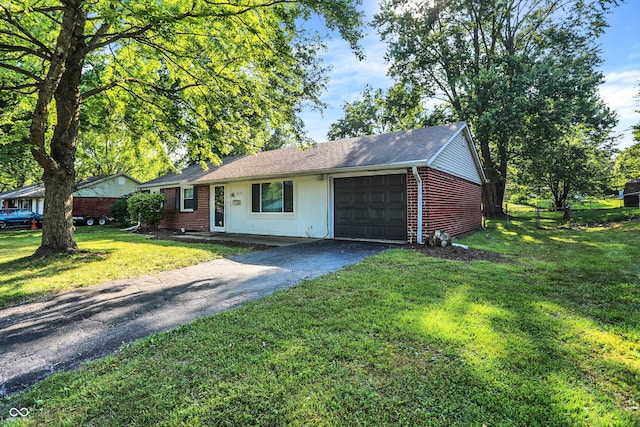 ranch-style home with a front yard and a garage