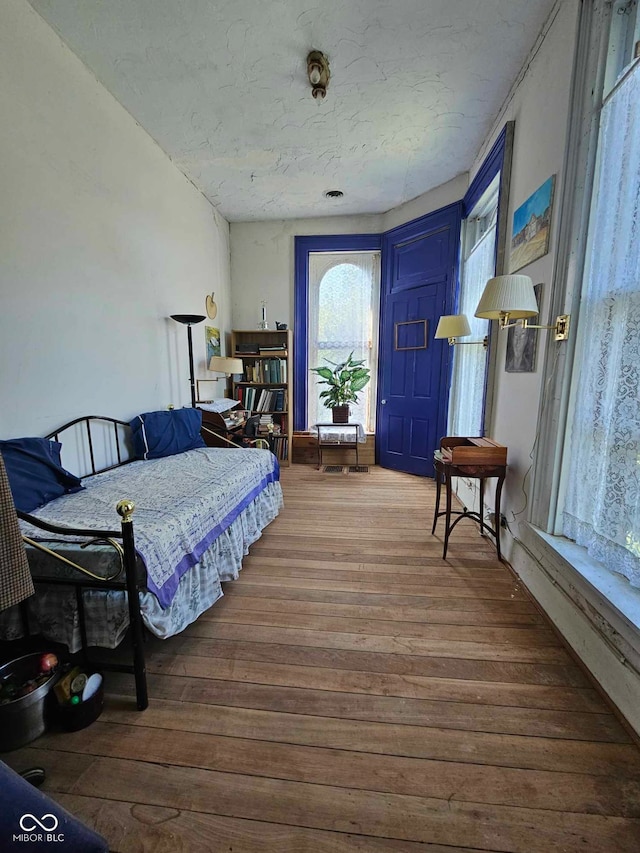 bedroom with hardwood / wood-style floors