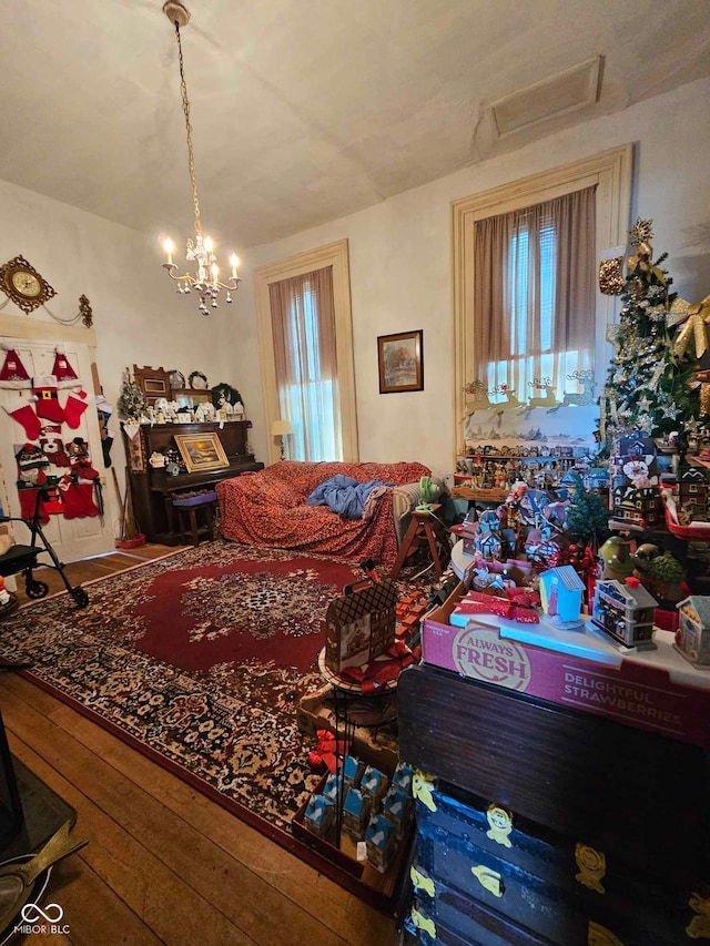 living room with hardwood / wood-style flooring and a chandelier