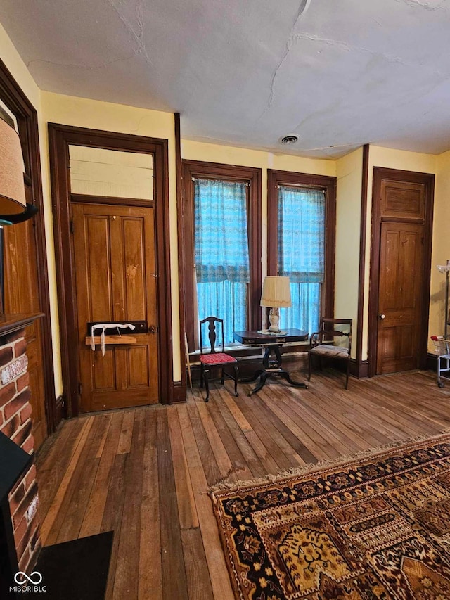 unfurnished room with hardwood / wood-style flooring and a textured ceiling