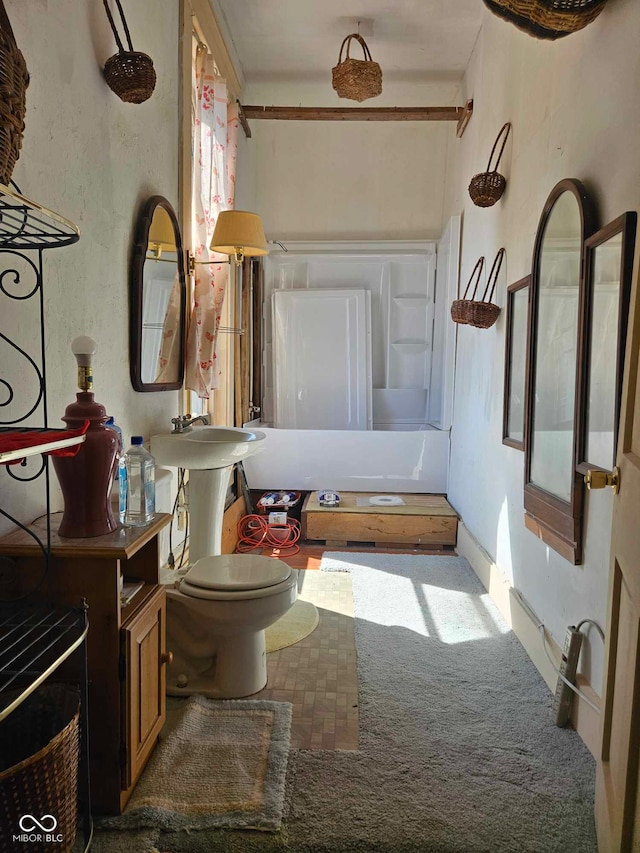 bathroom featuring tub / shower combination and toilet