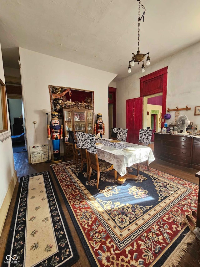 dining area featuring hardwood / wood-style flooring and a chandelier