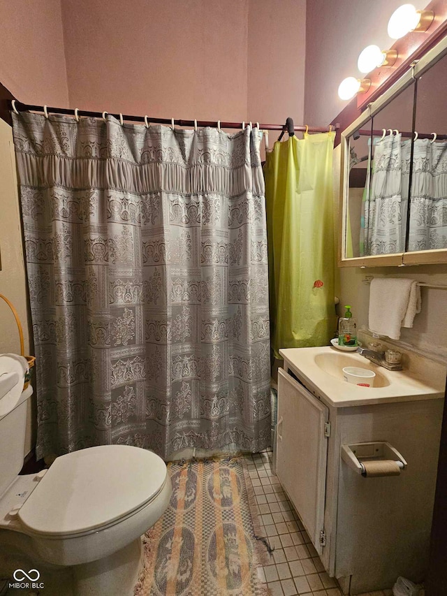 bathroom with a shower with curtain, vanity, tile patterned flooring, and toilet