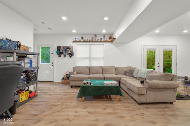 living room featuring light hardwood / wood-style flooring and french doors