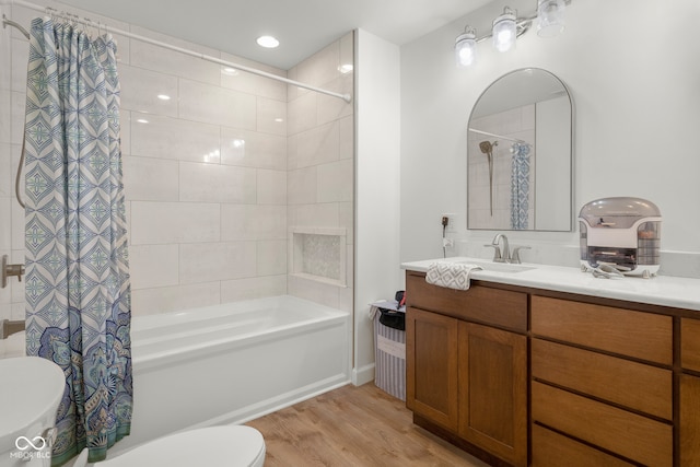 full bathroom featuring vanity, toilet, wood-type flooring, and shower / tub combo with curtain