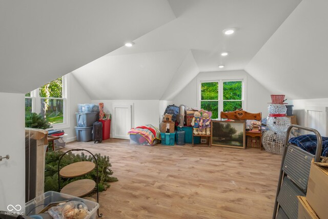 bonus room featuring lofted ceiling and light hardwood / wood-style floors