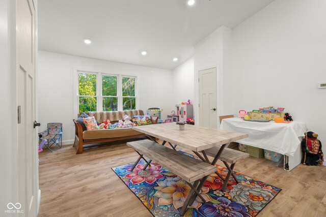 interior space with vaulted ceiling and light hardwood / wood-style flooring