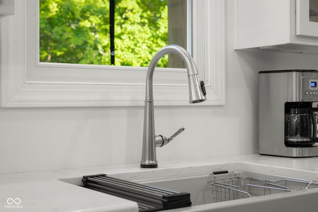 interior details with light stone counters and white cabinetry