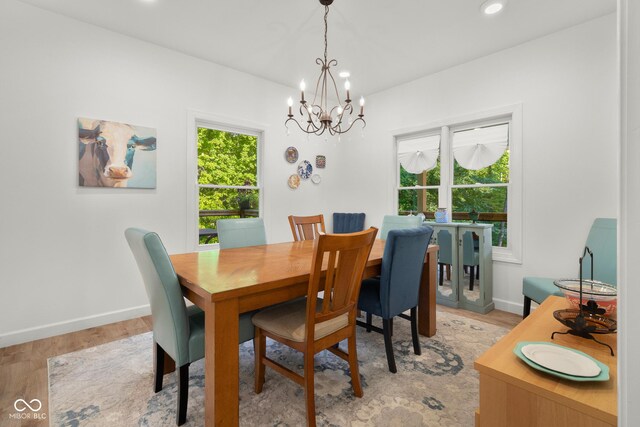 dining room featuring light hardwood / wood-style flooring and a notable chandelier