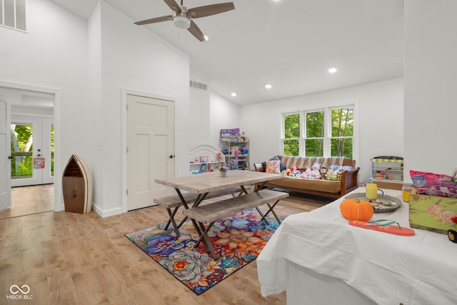 interior space featuring light wood-type flooring, high vaulted ceiling, and ceiling fan