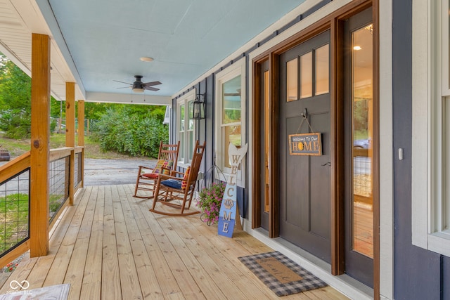 wooden terrace featuring ceiling fan and covered porch