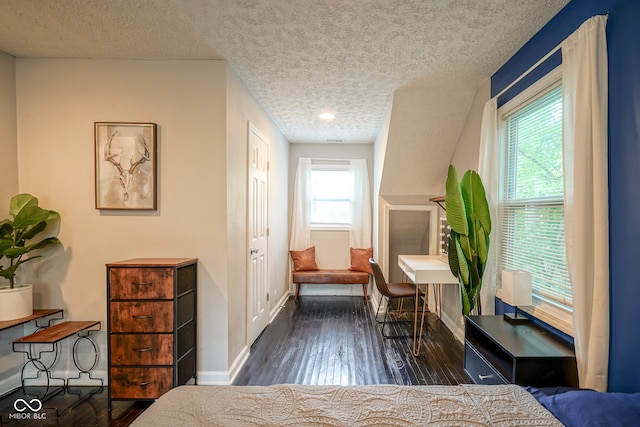 bedroom featuring dark hardwood / wood-style floors and a textured ceiling