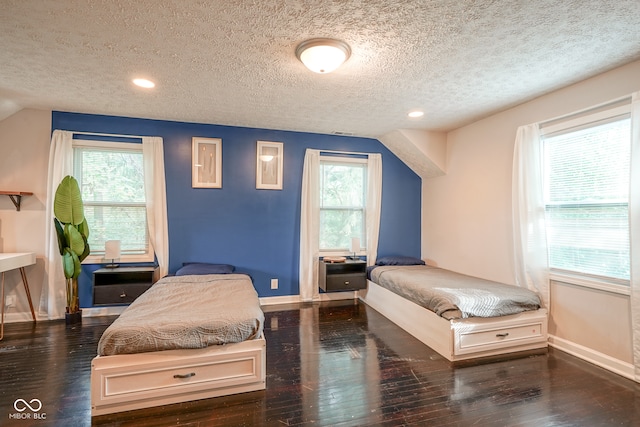 bedroom featuring a textured ceiling and hardwood / wood-style flooring