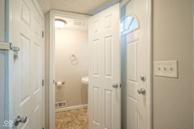 bathroom with a textured ceiling