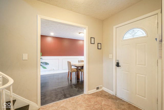 entrance foyer with a textured ceiling