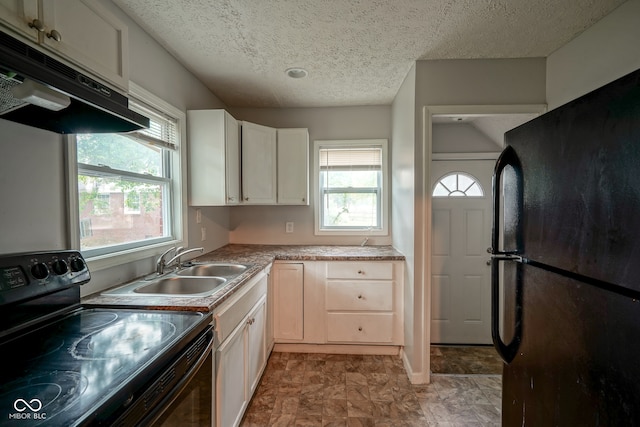 kitchen featuring a textured ceiling, black appliances, and sink