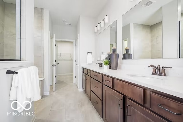 bathroom with tile patterned floors and vanity