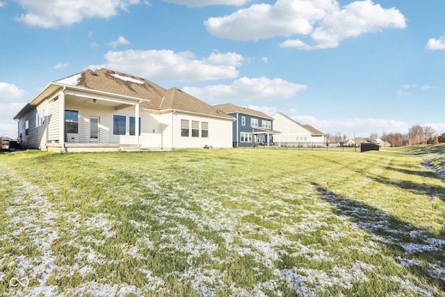 rear view of house with a lawn