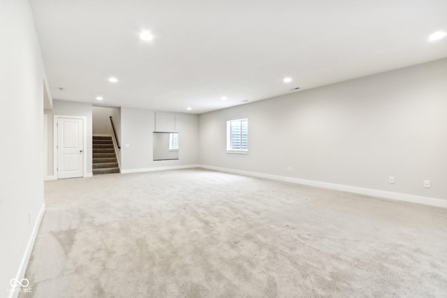 unfurnished room with light colored carpet