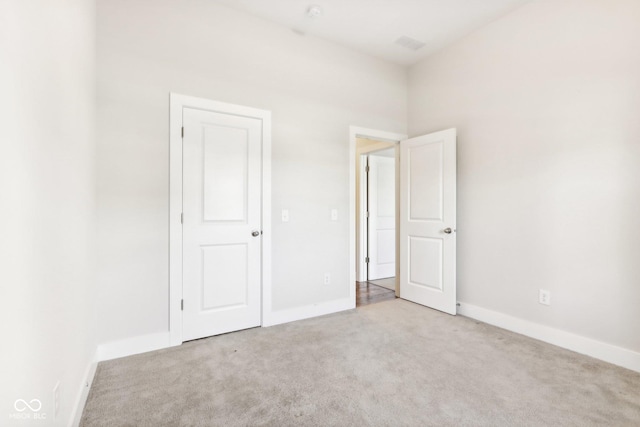 unfurnished bedroom featuring light carpet