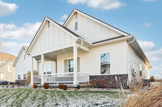 view of front of house with a porch and a lawn