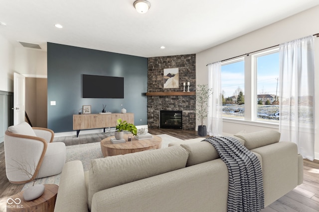 living room with wood-type flooring and a fireplace