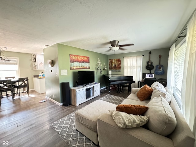 living room with a wealth of natural light, hardwood / wood-style floors, and ceiling fan