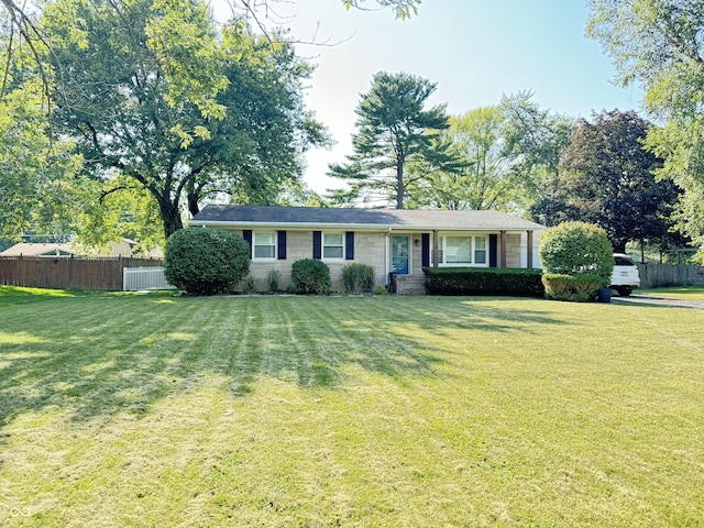 single story home featuring a front yard and fence