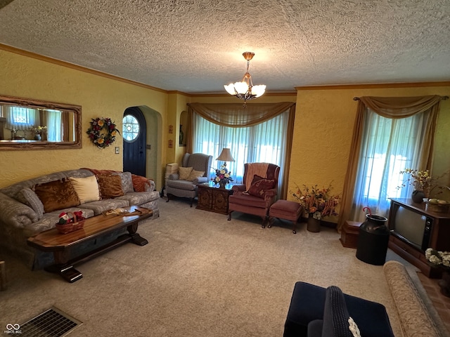 living room featuring a textured ceiling, an inviting chandelier, and carpet floors