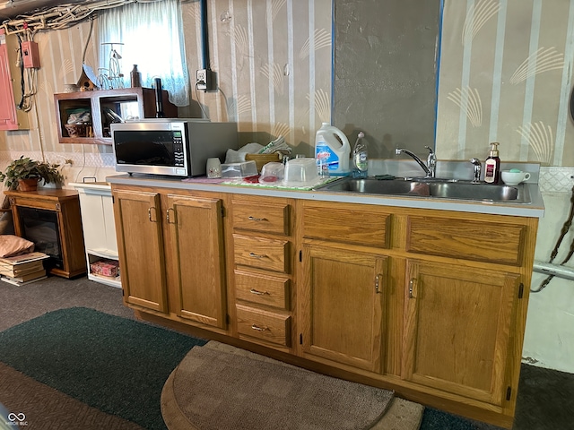 kitchen featuring sink and carpet floors