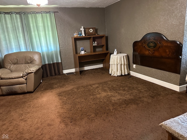 living area featuring a textured ceiling and dark carpet