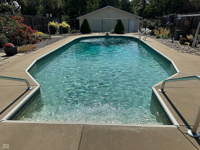 view of pool with an outbuilding