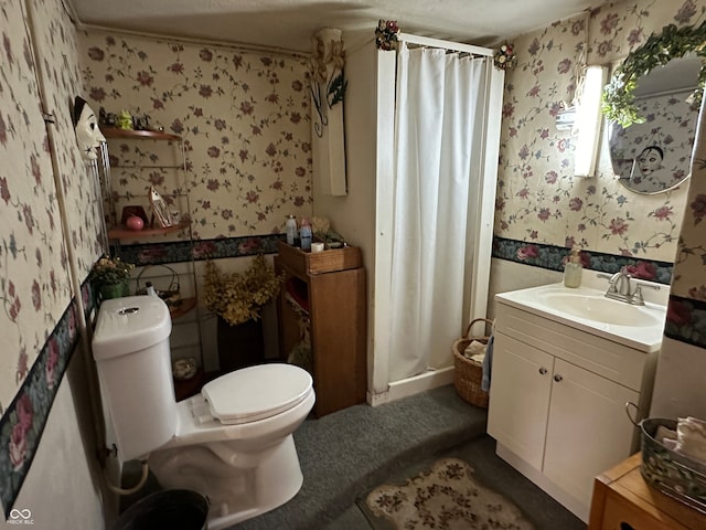 bathroom with vanity, toilet, and walk in shower