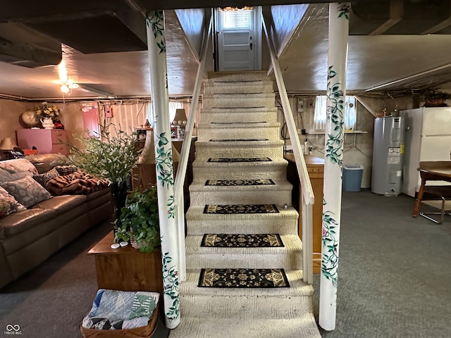 staircase with carpet, electric water heater, and ceiling fan