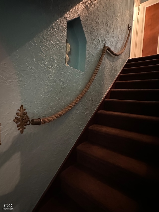 stairs featuring hardwood / wood-style flooring