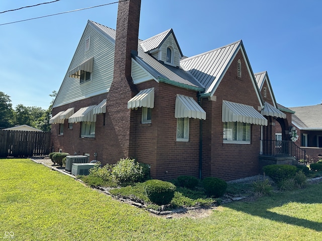 view of home's exterior featuring a lawn and cooling unit