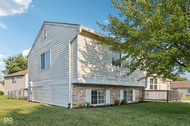 rear view of property with a lawn