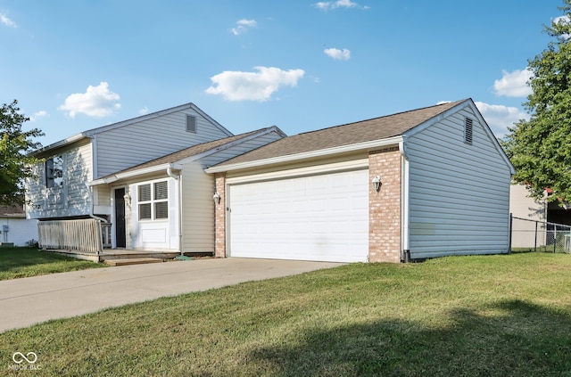 view of front of property with a front yard and a garage