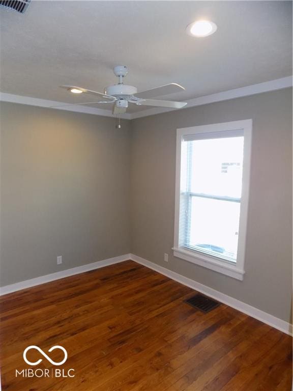 spare room featuring ceiling fan and dark hardwood / wood-style floors