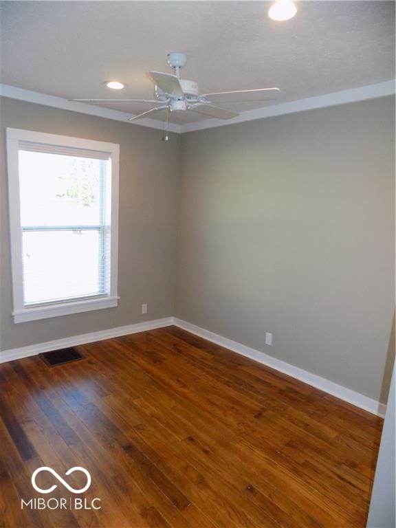 empty room with ceiling fan and hardwood / wood-style floors