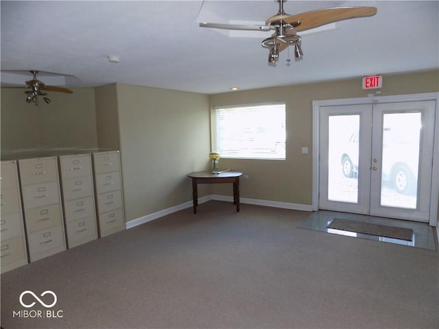 entryway with a wealth of natural light, light carpet, french doors, and ceiling fan