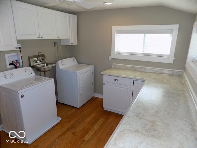 laundry room with washer and clothes dryer, sink, light wood-type flooring, cabinets, and ceiling fan