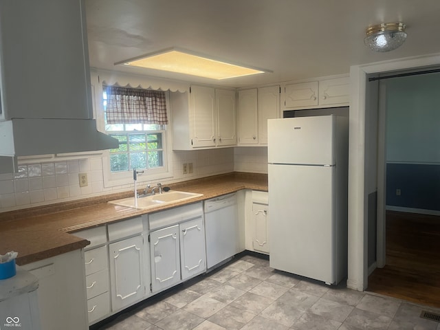 kitchen with tasteful backsplash, white appliances, sink, and white cabinets