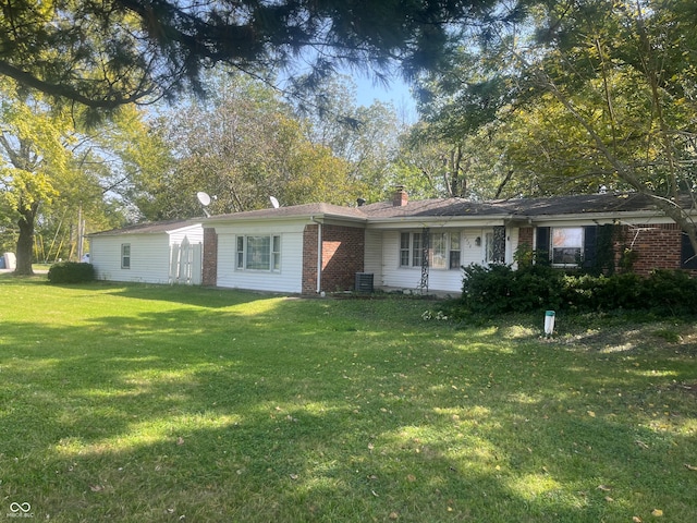 ranch-style house featuring central AC unit and a front yard