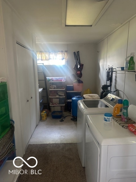 laundry room featuring light carpet and washer and clothes dryer