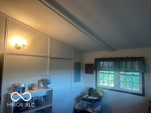 interior space featuring vaulted ceiling and electric panel