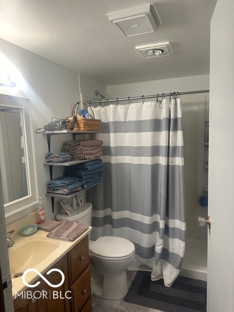 bathroom with tile patterned floors, walk in shower, toilet, and vanity