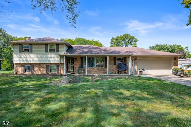 split level home with a garage and a front lawn